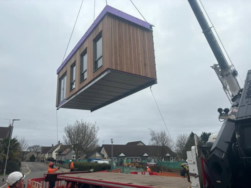 A modular classroom being installed with a crane